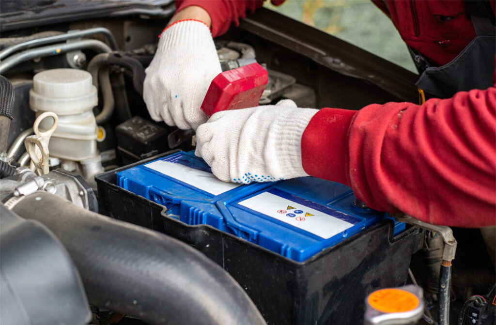 Stock Image of Technician Replacing a 12V Car Battery